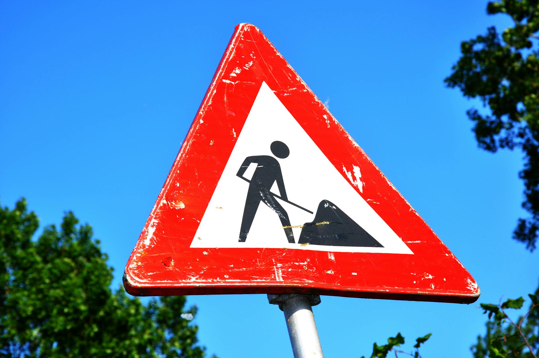 close up photography of red and white road signage